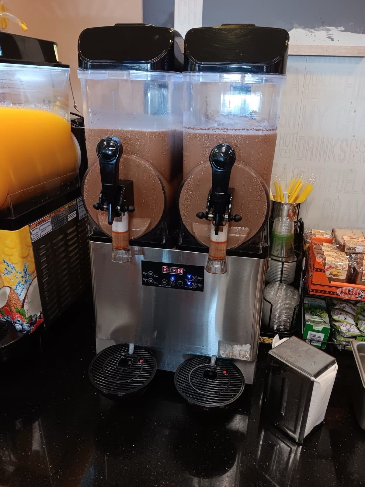 Stainless-steel twin-tank slush machine churning two tanks of frozen Froffee
